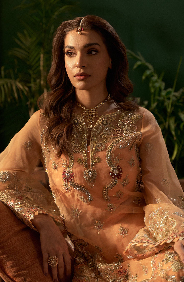 Close-up of Morganite peach dress with elegant ruching on the bodice and subtle beadwork for a refined look